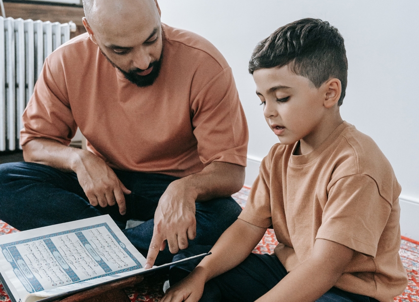 an image of a man supporting a small boy with a lesson